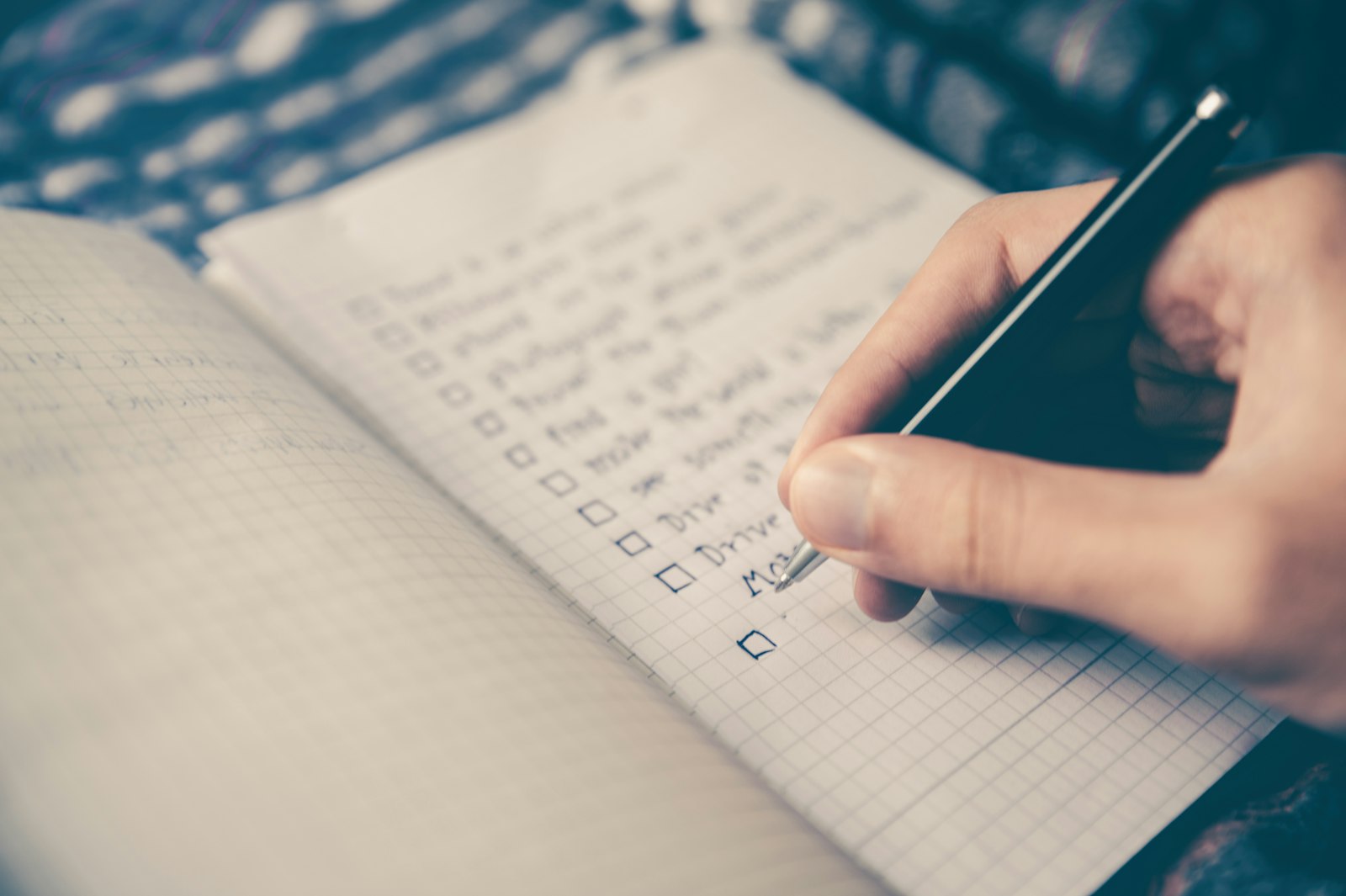 Person writing goals in a notebook representing personal growth and focus