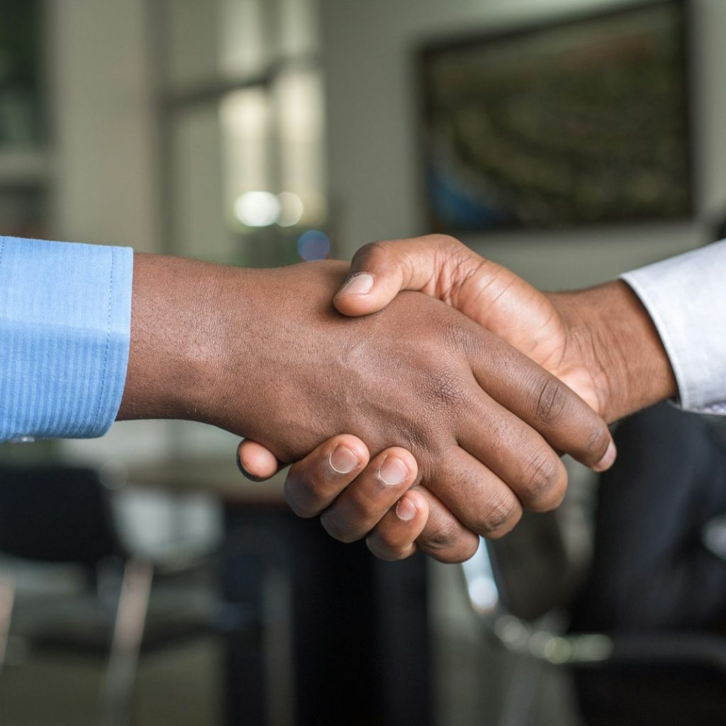Two people shaking hands representing customer trust and service