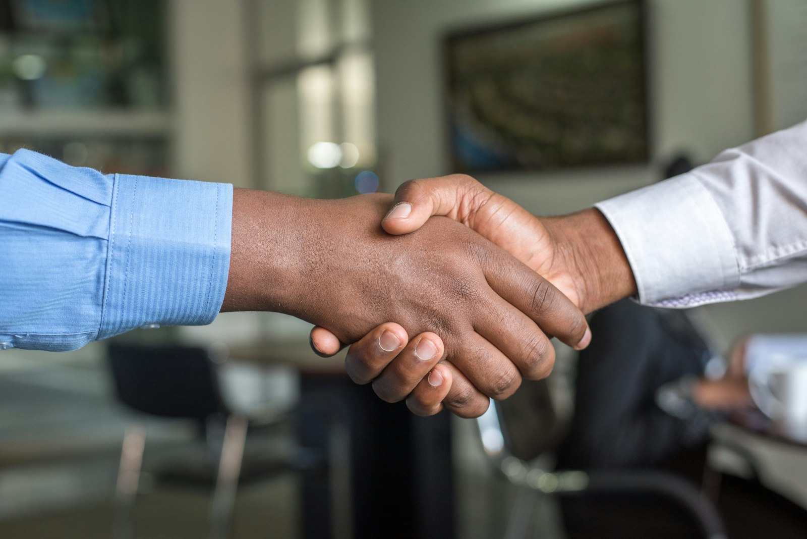 Two people shaking hands representing customer trust and service