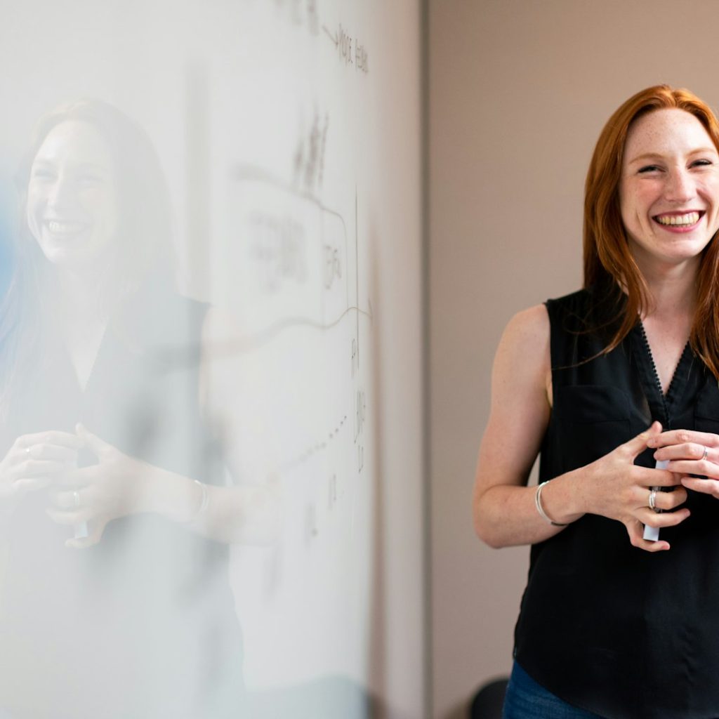 Professional presenting workplace skills training at a whiteboard